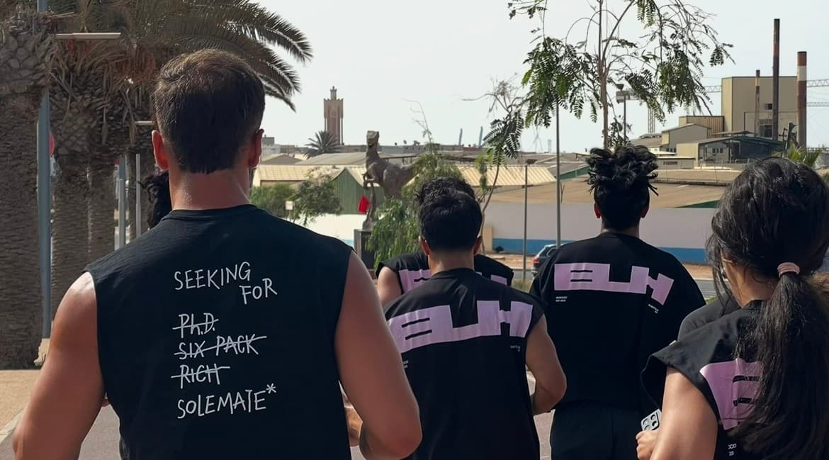 Runners on a trail with mountains in the background